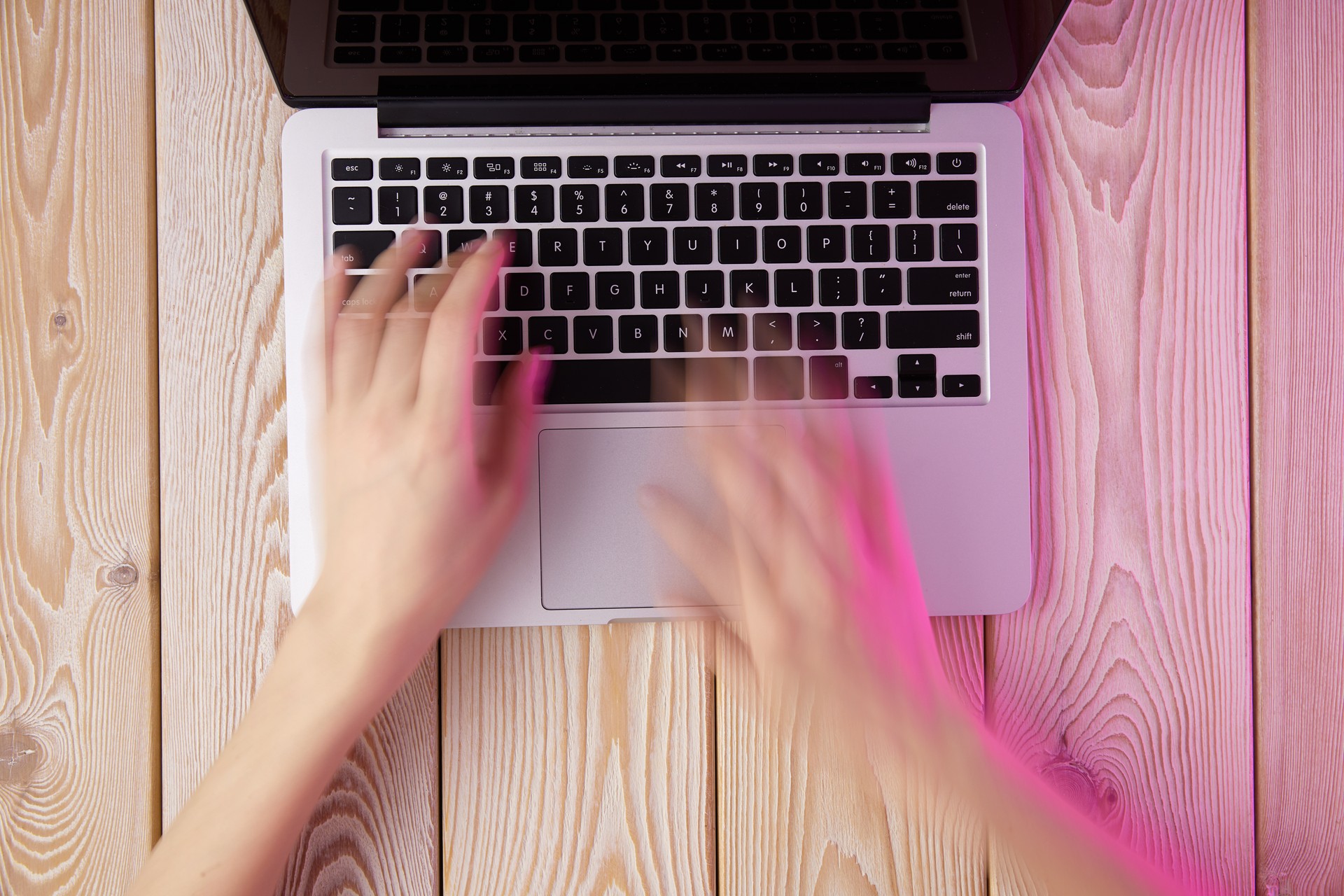 Image of woman"u2019s hands typing fast on laptop keyboard. View from above. Remote work concept image.